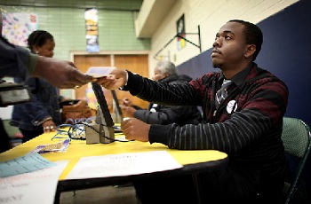 High school student working at the polls